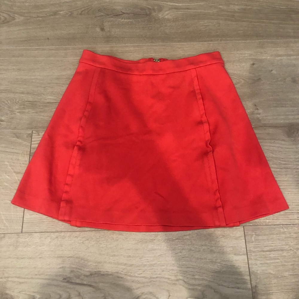 Bright orangish red skirt with gold zipper